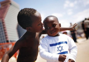 Children of African asylum seekers play on a Tel Aviv beach on Independence Day (photo credit: Reuters)